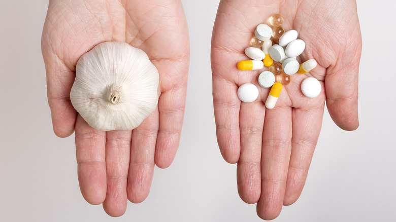 Head of garlic, with tablets, pills, and oil