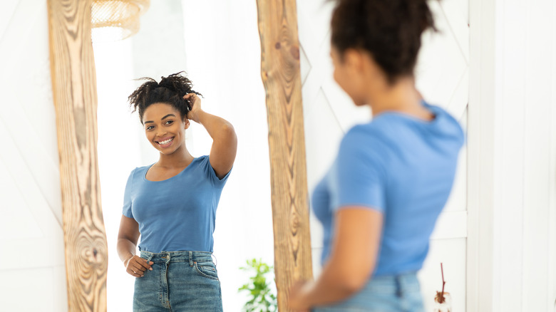 woman looking at herself in the mirror