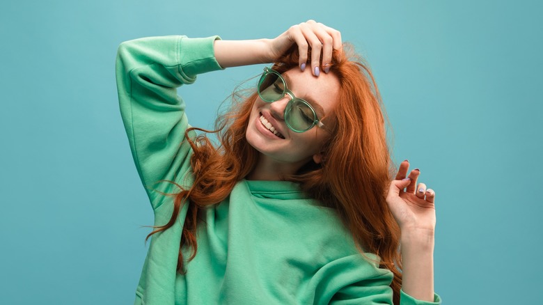 Woman wearing green-tinted glasses