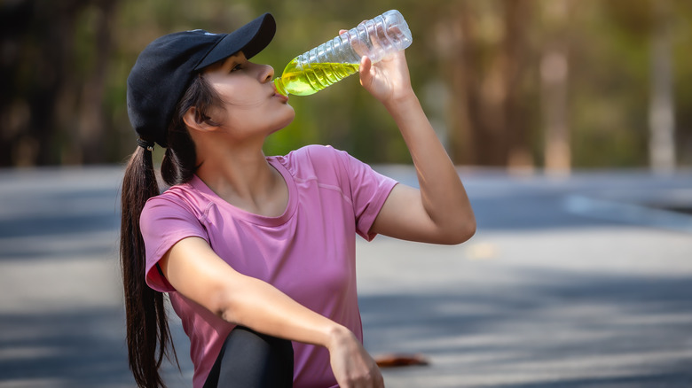 woman drinking electrolytes