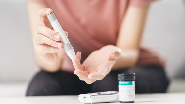 woman checking her blood sugar levels