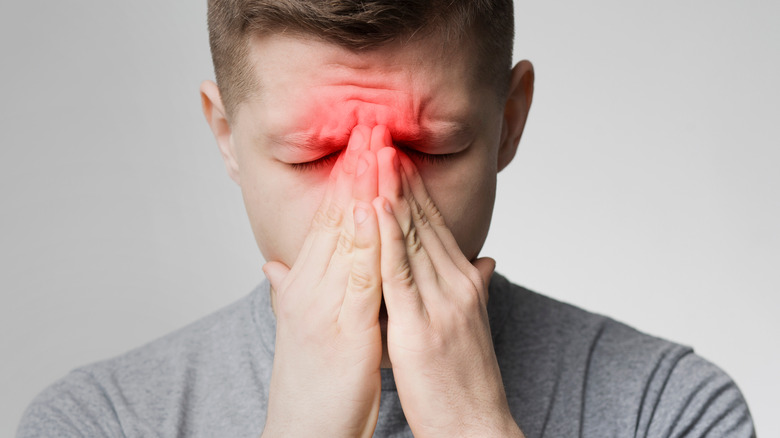 man suffering from sinus pain