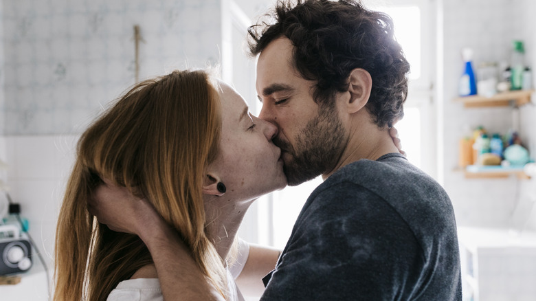 A couple kissing in the bathroom