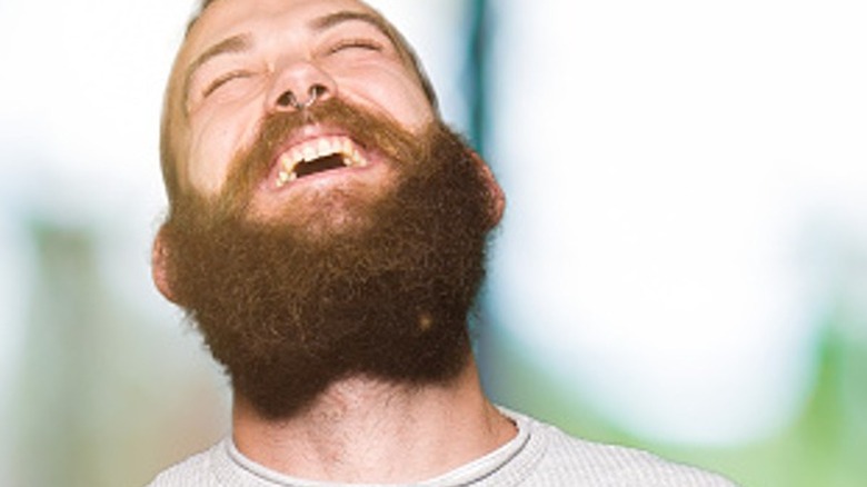 Young man laughing hard