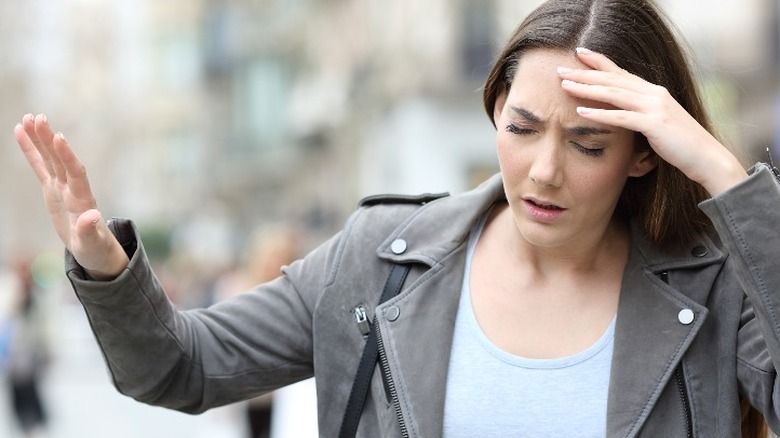 Woman feeling dizzy in the street