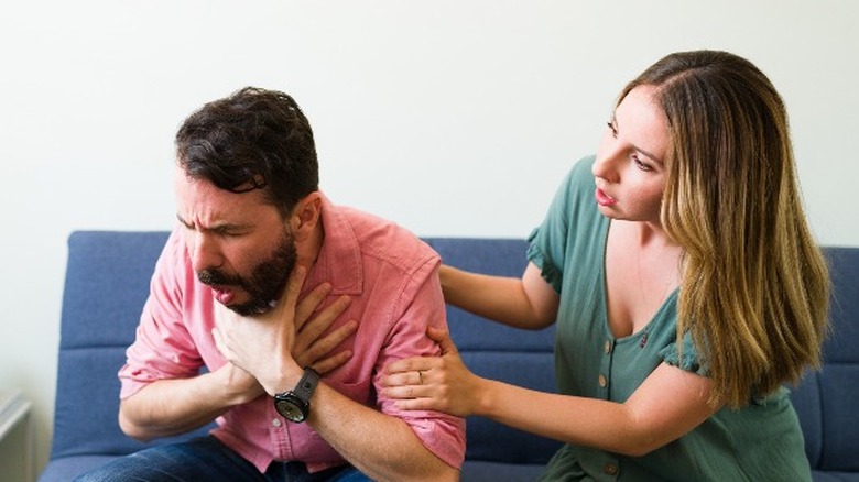 Man choking on couch