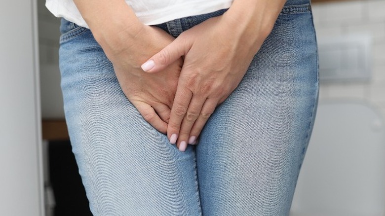 Woman trying to hold urine in