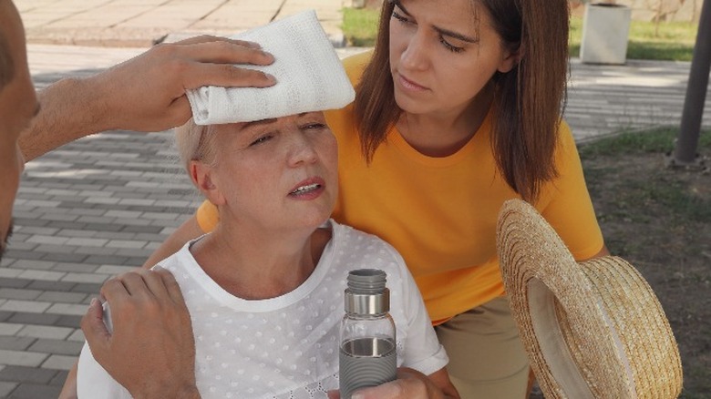 People helping woman who fainted