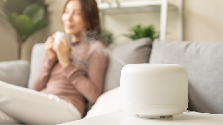 woman enjoying essential oil diffuser 