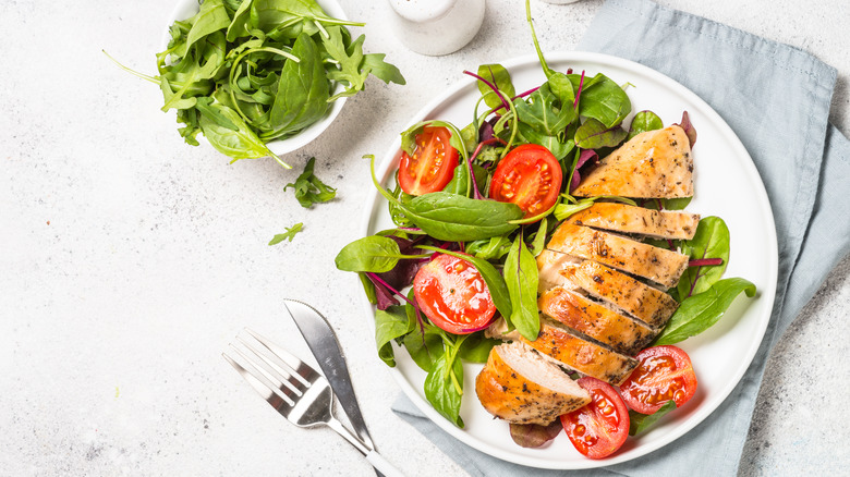 Plate with grilled chicken and salad