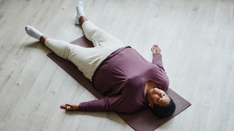 woman lying down meditating