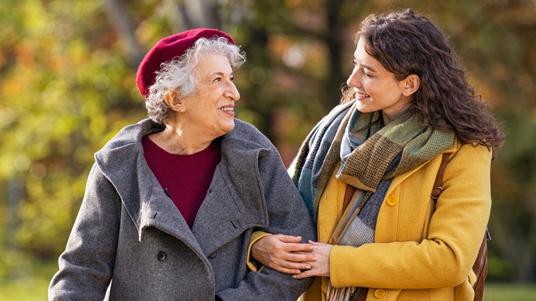 older woman and younger woman walking outdoors