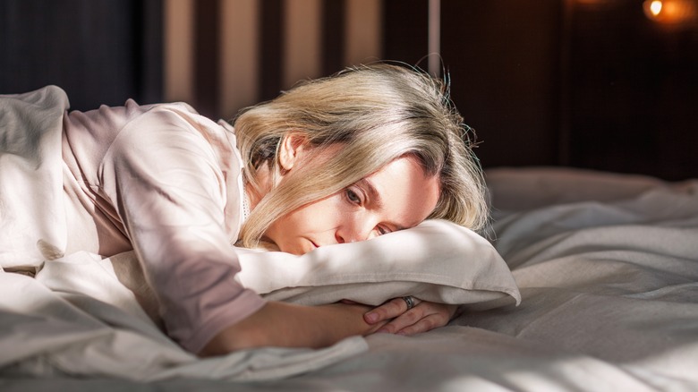 woman experiencing depression in bed 