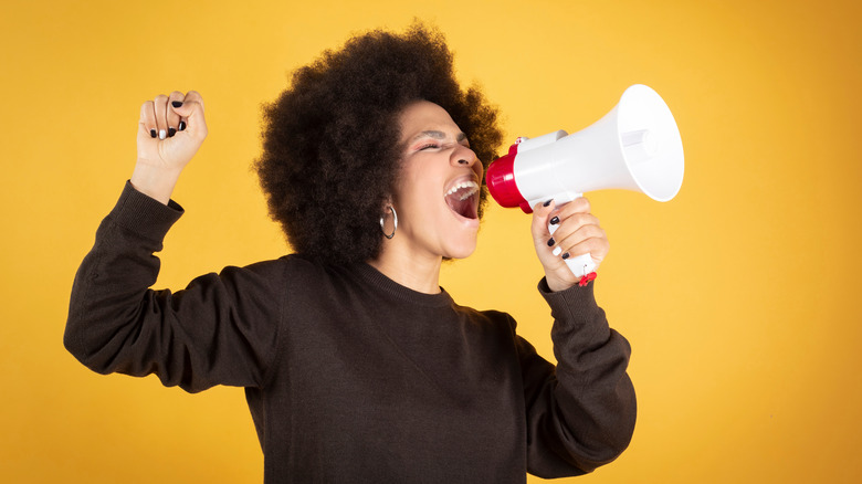 Woman yelling into bullhorn