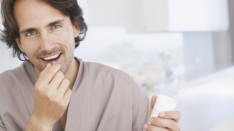 young man taking a supplement