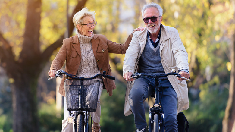 Smiling senior couple riding bikes