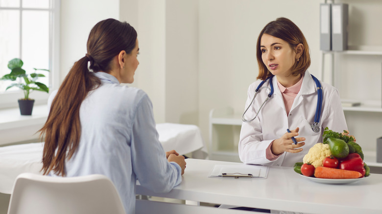 woman speaking with nutritionist in office