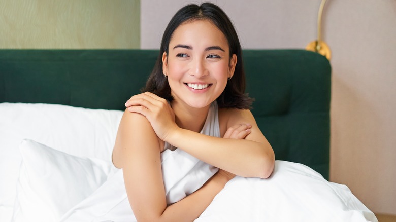 Woman smiling after good night's sleep