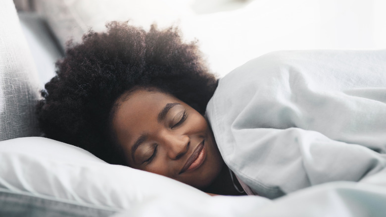woman sleeping and smiling 