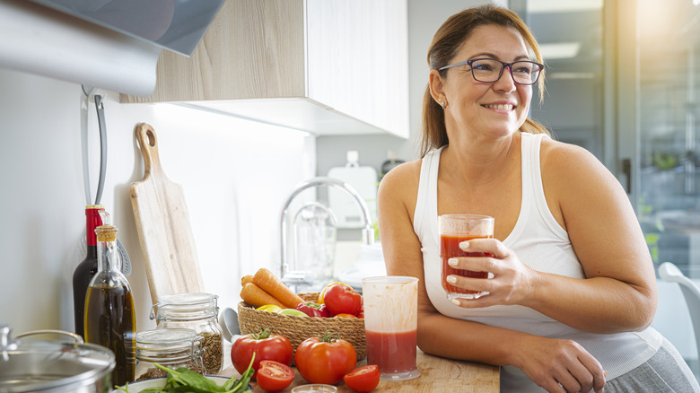 woman drinking fresh tomato juice