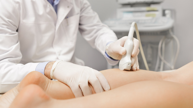 doctor performing treatment on patient