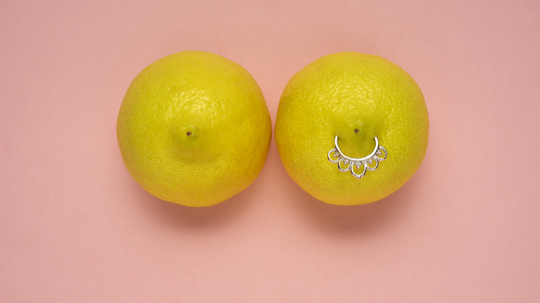 two lemons represent breasts, one is pierced 