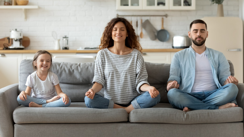 Adults and child sitting on couch