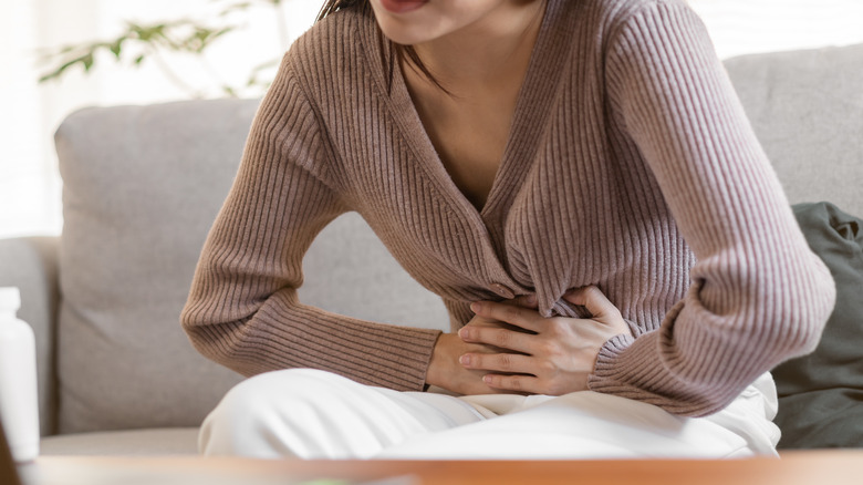 woman holding stomach