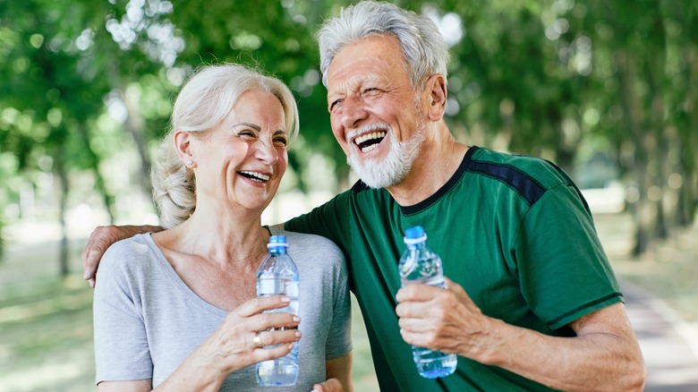 older couple drinking bottled water