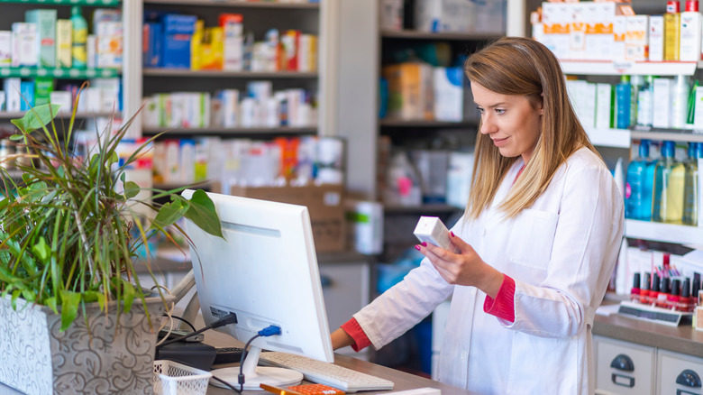 pharmacist standing at a computer 