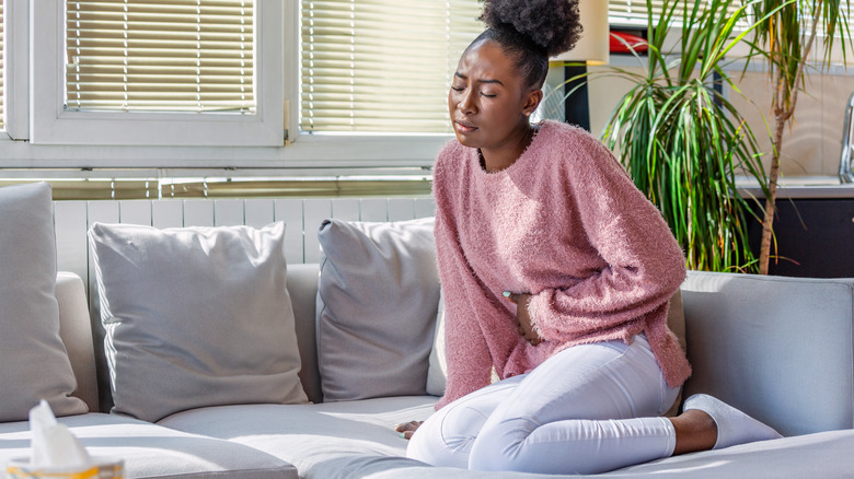 Woman holding stomach in pain