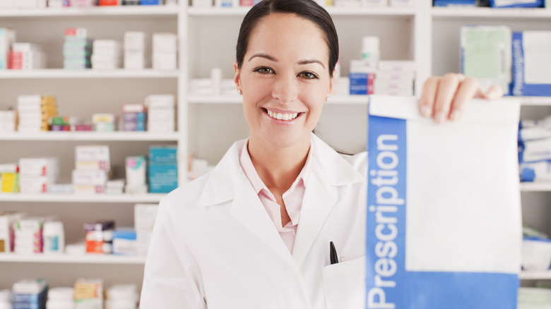 pharmacist handing over a prescription