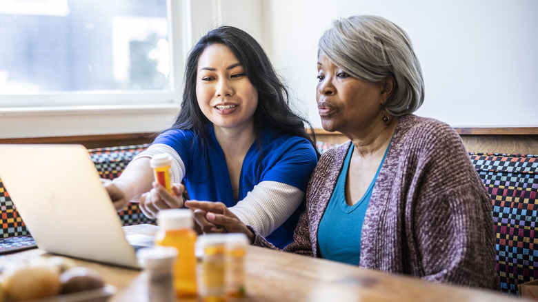 woman reviewing prescriptions with healthcare provider