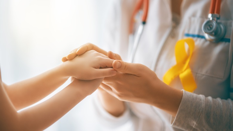 doctor holding patient's hand
