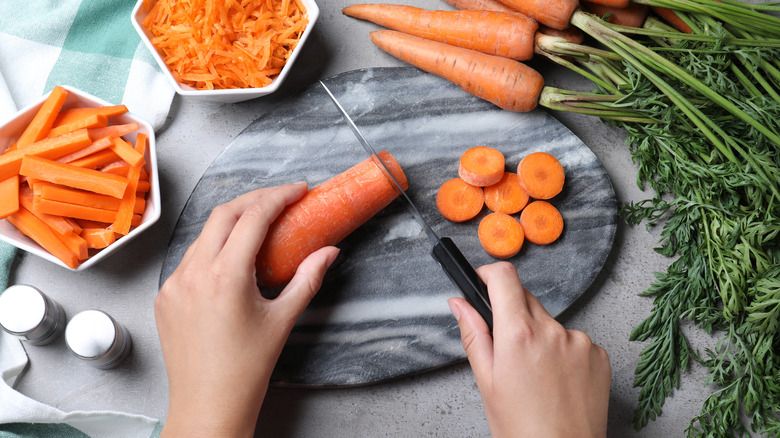 Woman chopping carrots