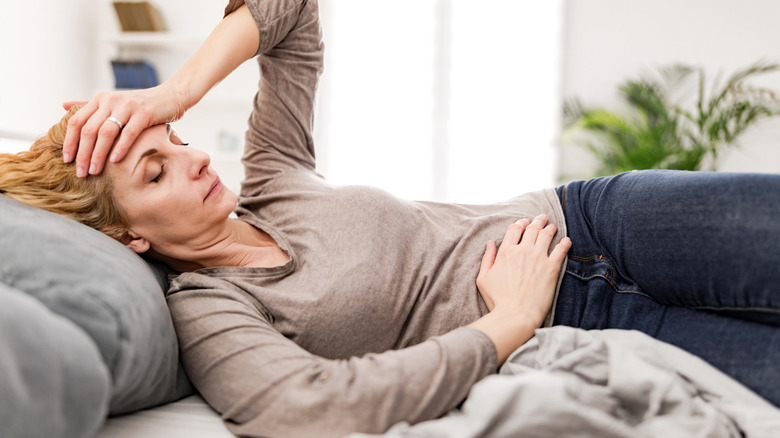 A woman lying in bed sick