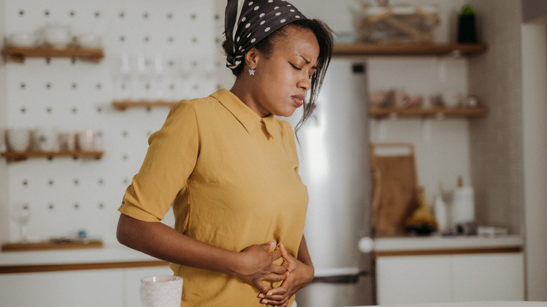 A woman experiencing stomach pain