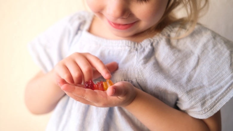 young girl finding a gummy bear