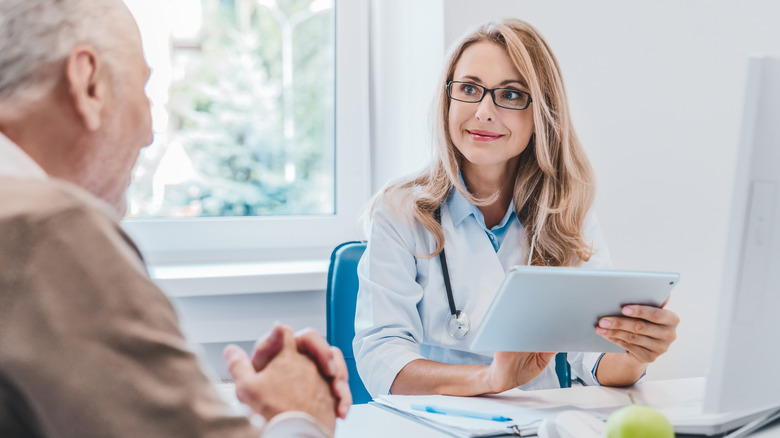 woman doctor talking to man