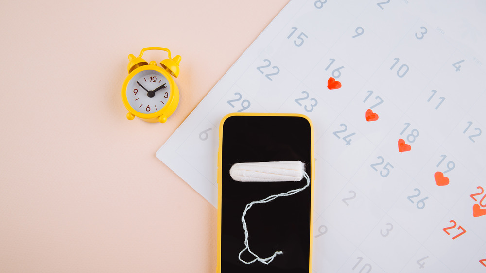 phone, tampon and small clock