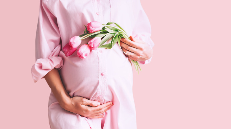Pregnant woman with pink flowers