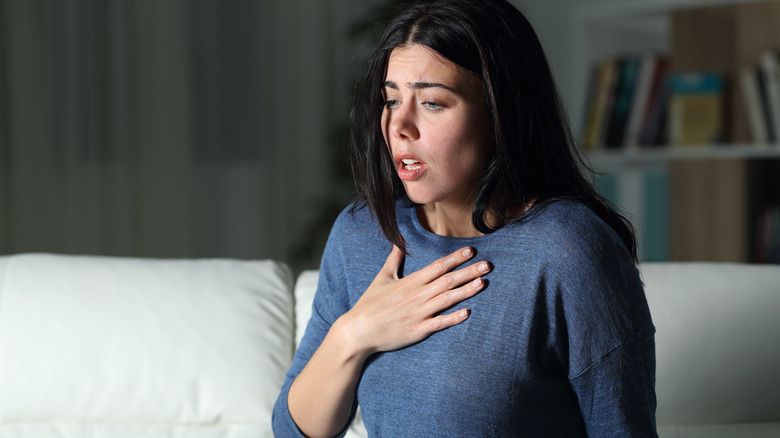 woman holding chest