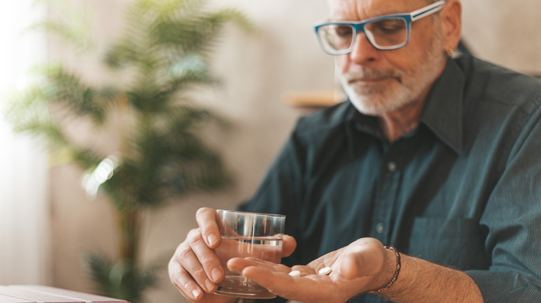 man taking medications