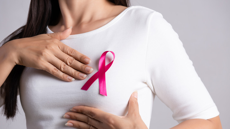 woman holding ribbon breast cancer awareness