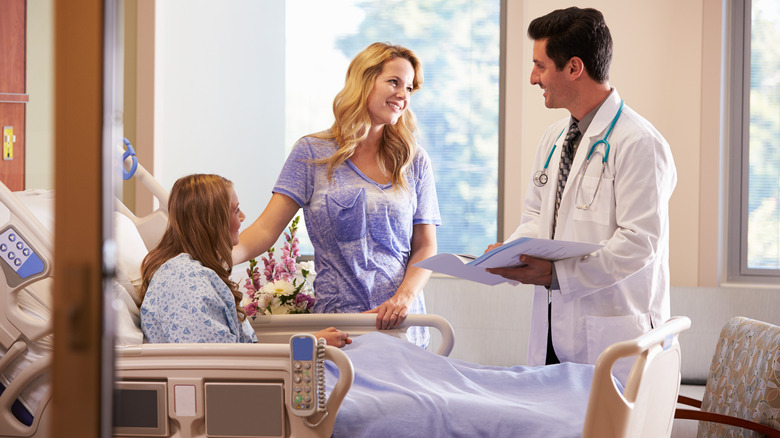 Mom and hospitalized daughter speaking with doctor