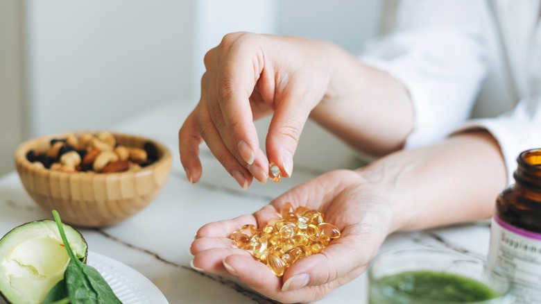 woman with handful of vitamins