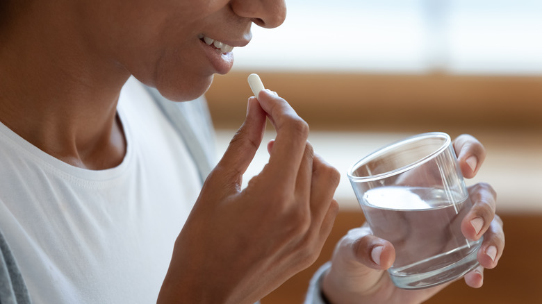 Woman taking biotin supplements