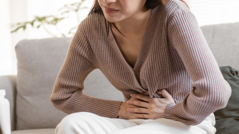 woman holding stomach