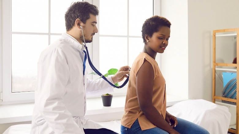 white doctor with black female patient