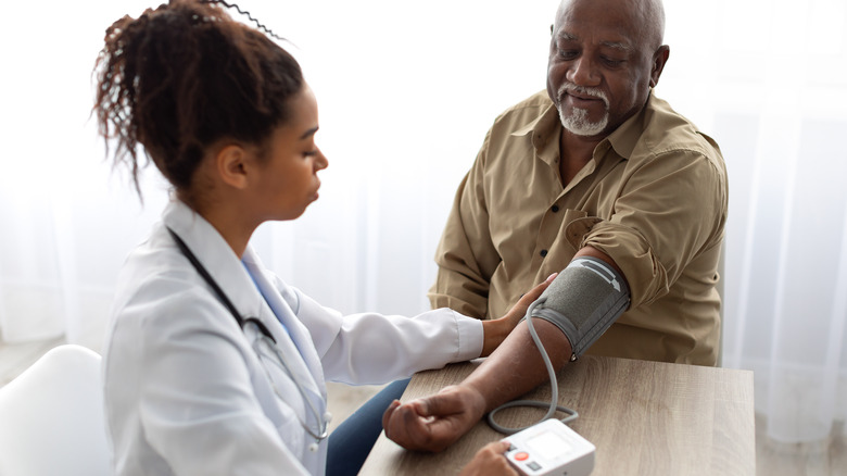 Doctor measuring patient blood pressure